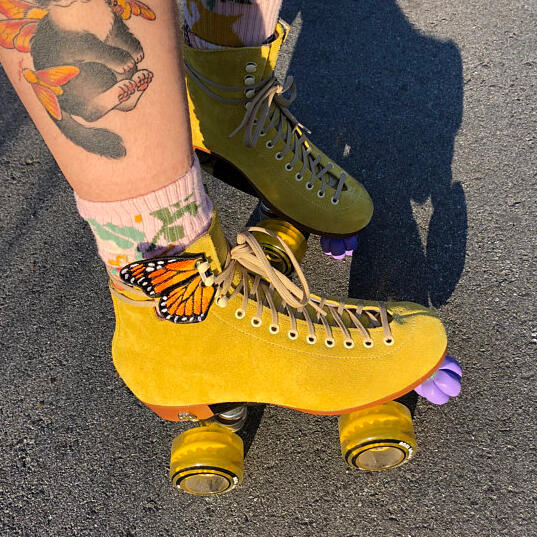 Roller skates with Stitchers3 butterfly wings attached.